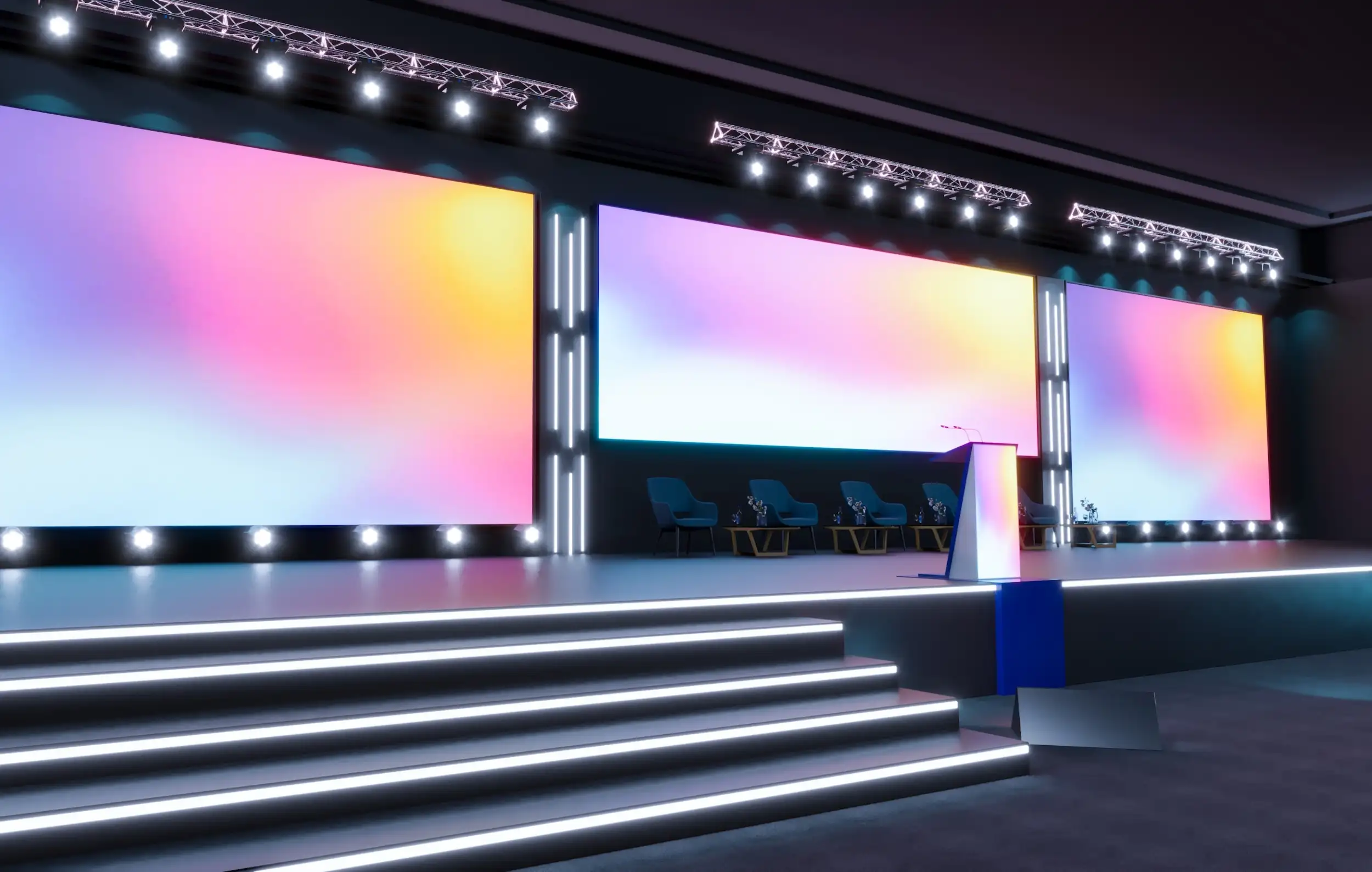 Conference stage with large LED video walls displaying colorful gradient graphics and a podium
